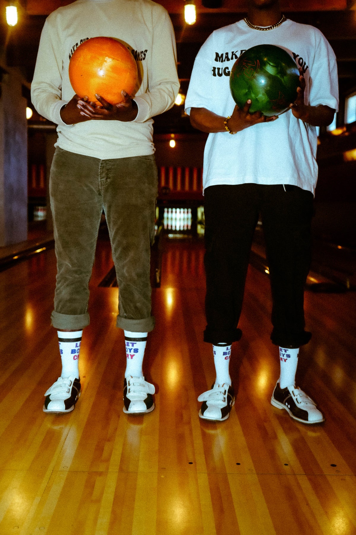 two-friends-holding-bowling-balls