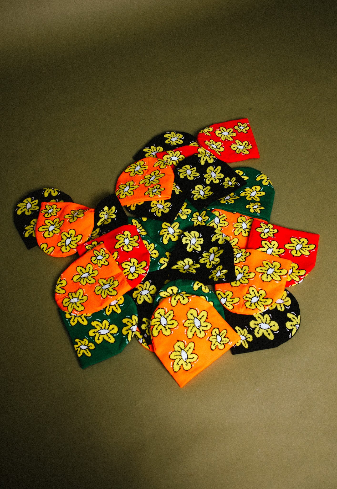 Not A Bad Life's Flower Beanies in red, orange, black, and greem