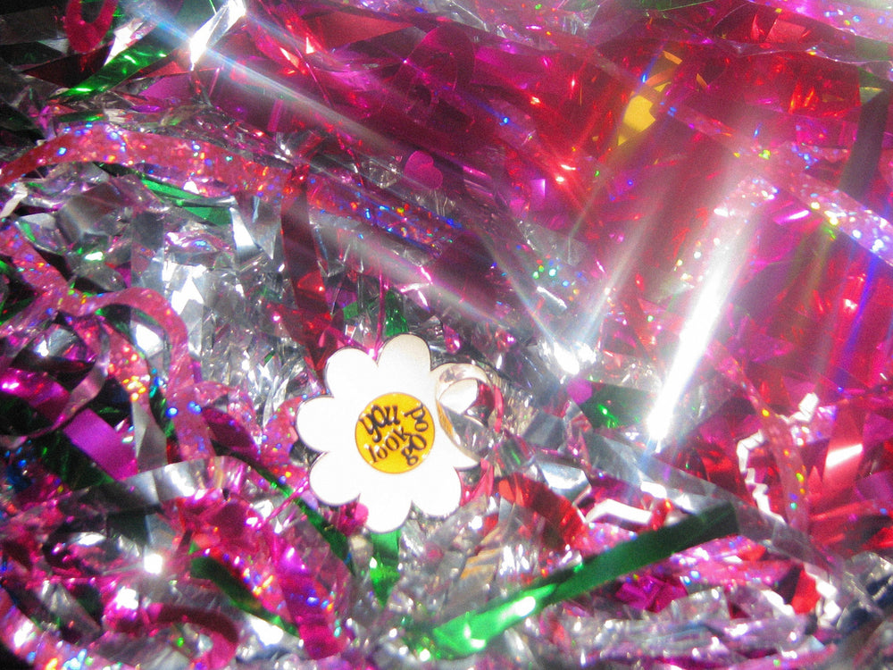 Flower pin laying in colorful fringes