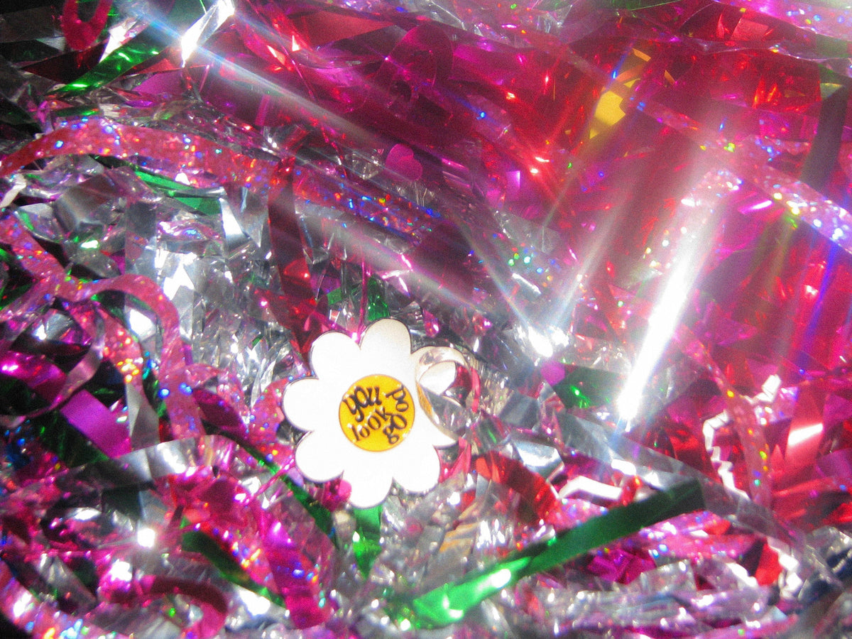 Flower pin laying in colorful fringes