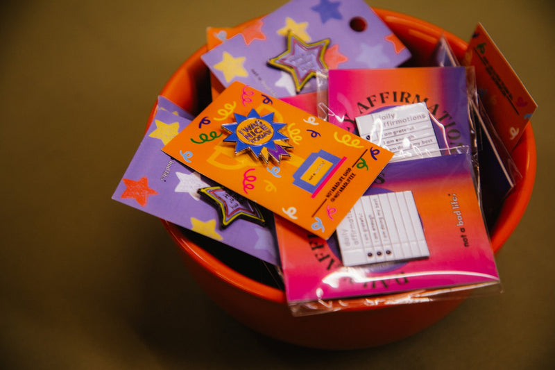 I was nice today and daily affirmation pins inside of an orange bowl