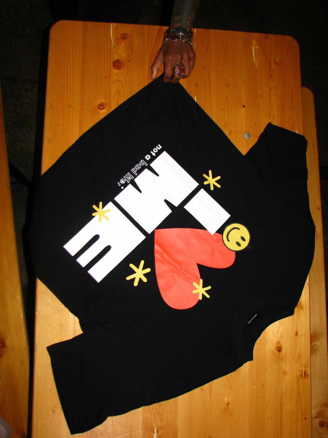 I Love Me Tee on a table